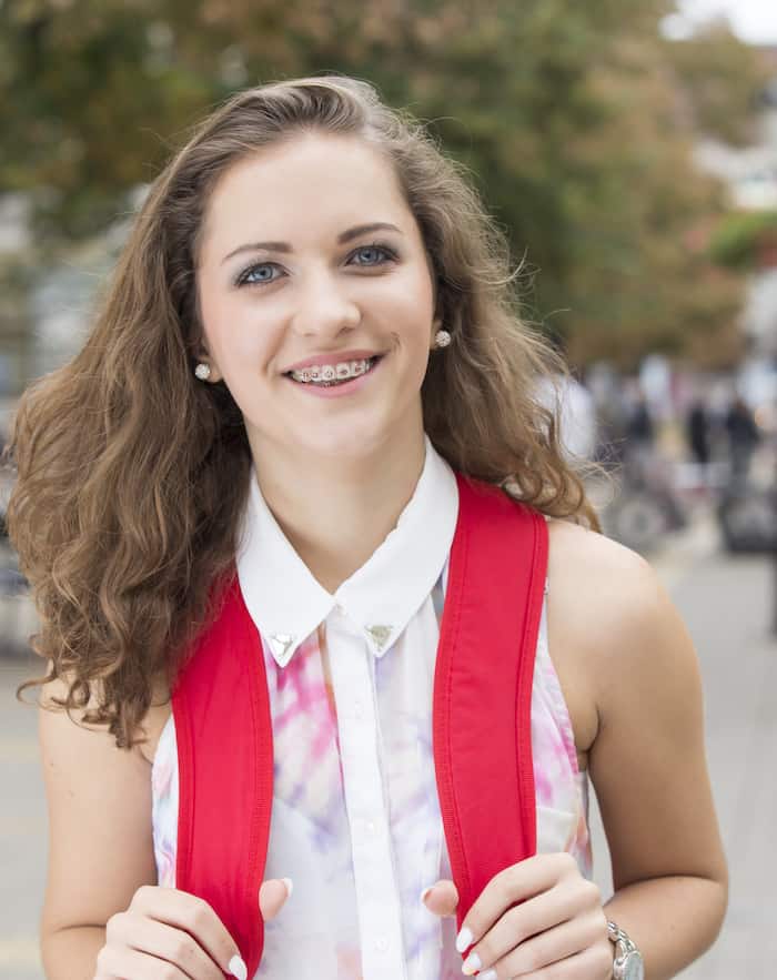 smiling female patient with teen braces in Bee Cave, TX